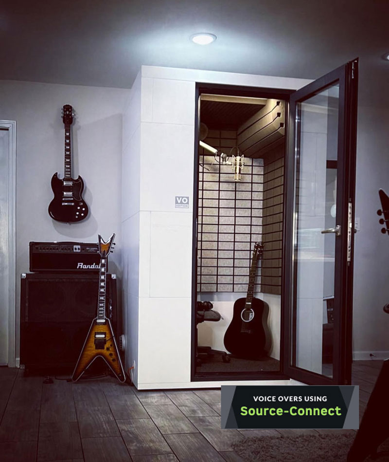 Voice Overs Using Source Connect. Photo of Cory Tabor Voice Over Sound booth with professional microphone and acoustic and electric guitars